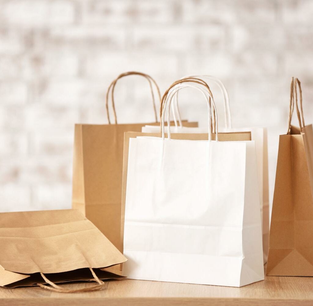 Many Paper Shopping Bags On Table